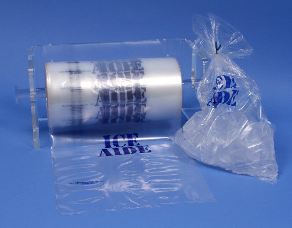 Ice bag roll on dispenser with ice bag filled with ice next to it